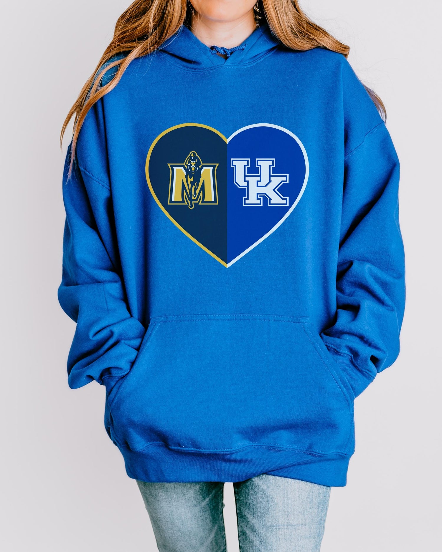 a woman wearing a blue hoodie with the letter m and k on it